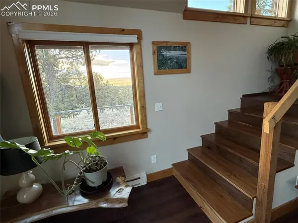 a room with wooden floor and lots of windows