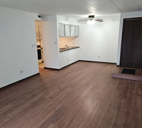 wooden floor in an empty room with a fireplace