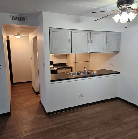 a room with wooden floor and chandelier