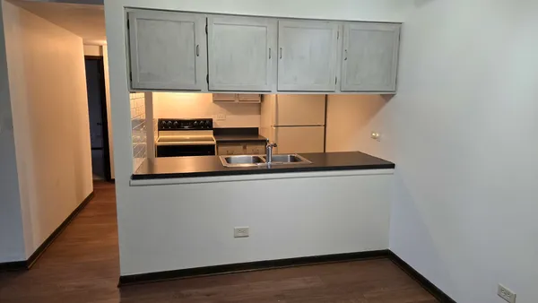 a room with wooden floor and utility
