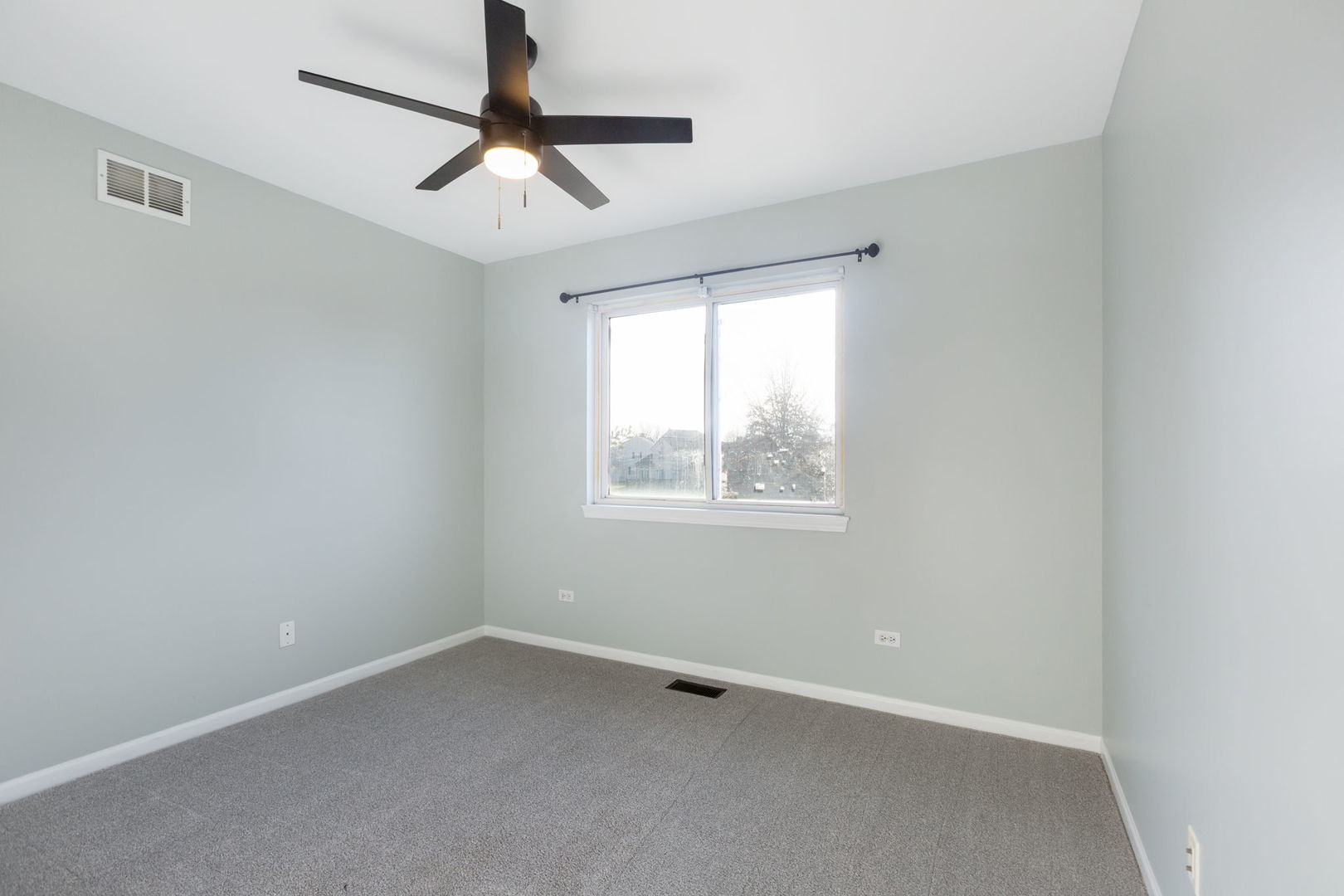 2020 Spring Creek Lane McHenry, IL 60050 - Photo 12 of 17 an empty room with a window and a fan