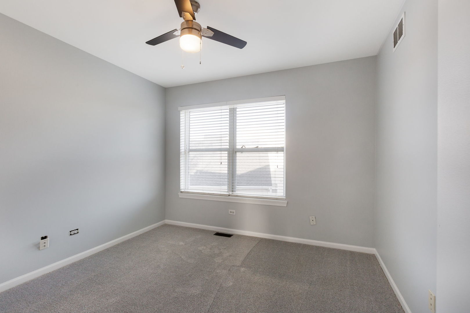 2020 Spring Creek Lane McHenry, IL 60050 - Photo 14 of 17 an empty room with a window and a fan