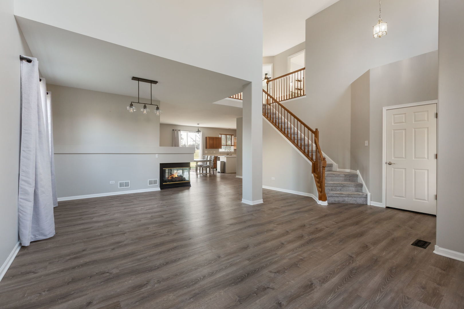2020 Spring Creek Lane McHenry, IL 60050 - Photo 2 of 17 a view of a livingroom with wooden floor and staircase