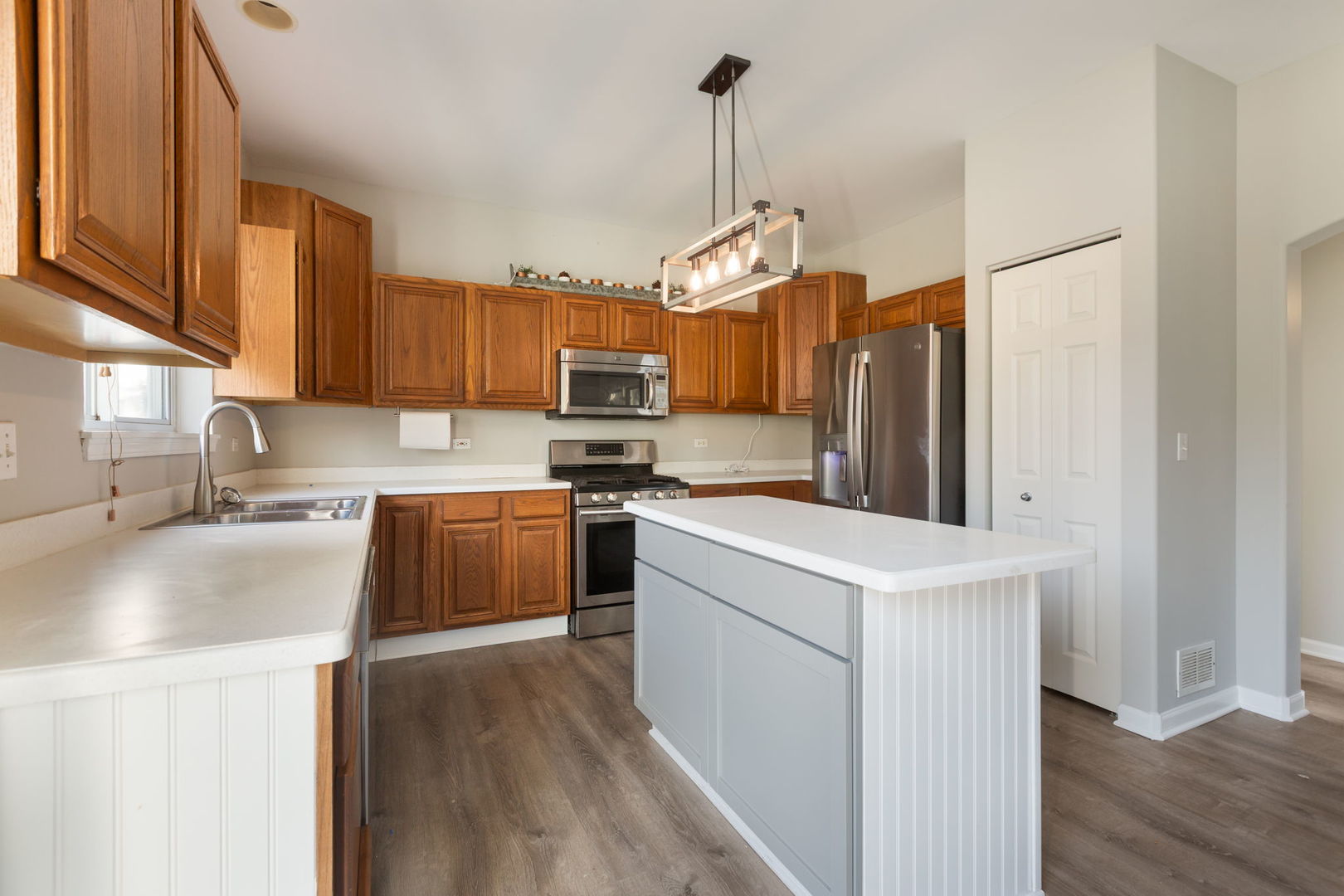 2020 Spring Creek Lane McHenry, IL 60050 - Photo 5 of 17 a kitchen with stainless steel appliances granite countertop a sink a stove a refrigerator a center island with wooden floor and cabinets