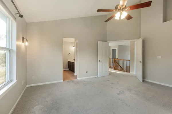 an empty room with fan and entrance