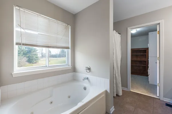 a bathroom with a bathtub and a shower