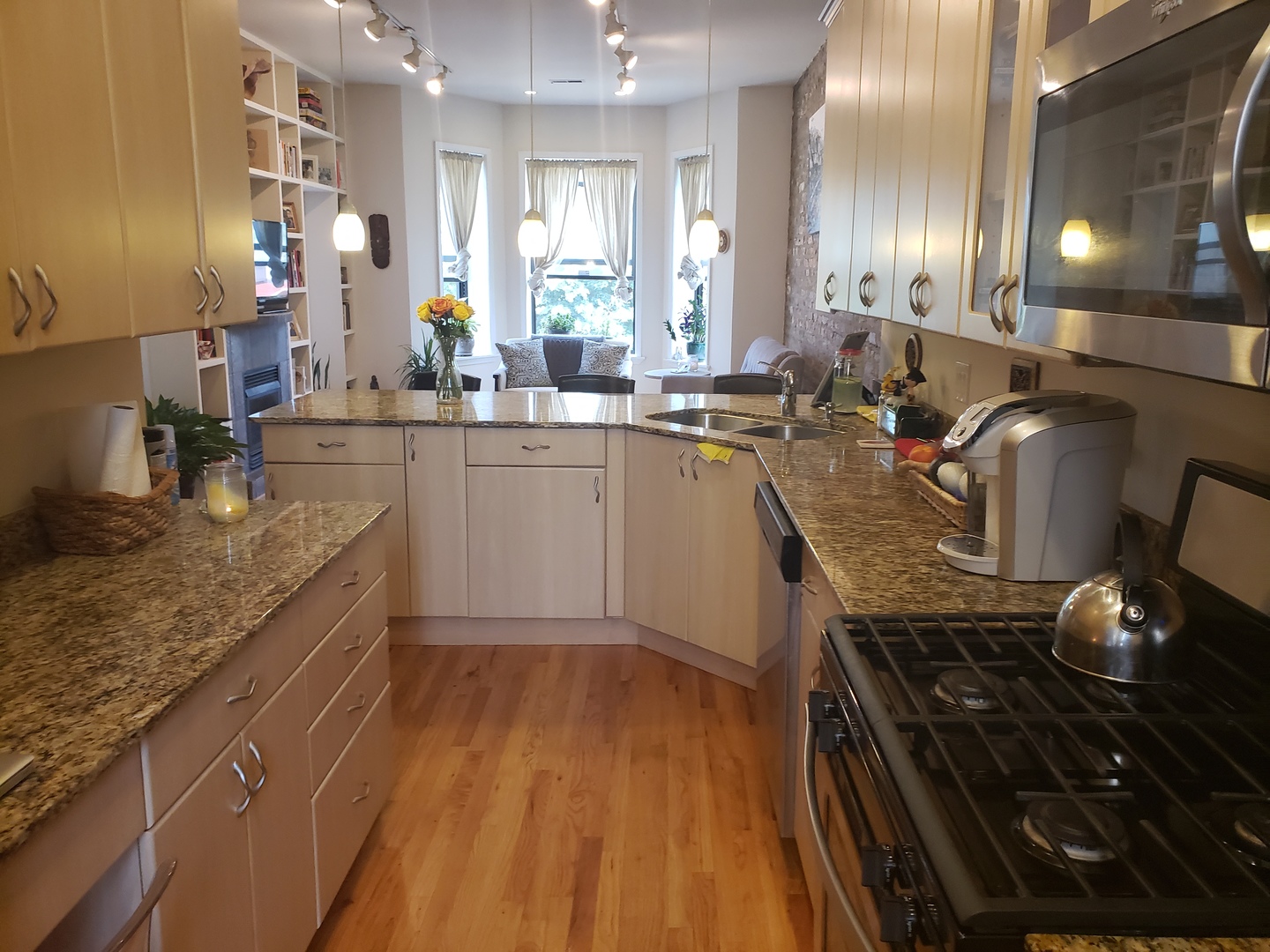 5946 South Prairie Avenue, Unit 2S Chicago, IL 60637 - Photo 11 of 18 a kitchen with kitchen island granite countertop lots of counter top space and stainless steel appliances