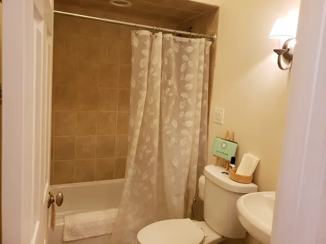 a white toilet sitting next to a bathroom sink