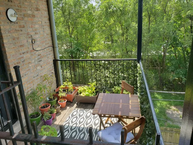 a view of balcony with furniture and garden view