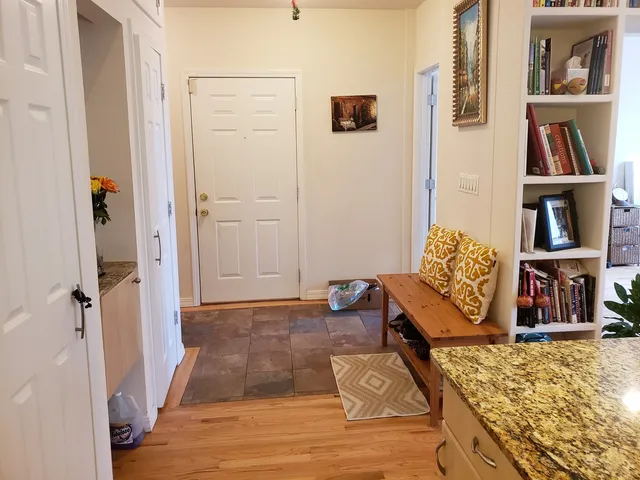 a living room with furniture and a book shelf