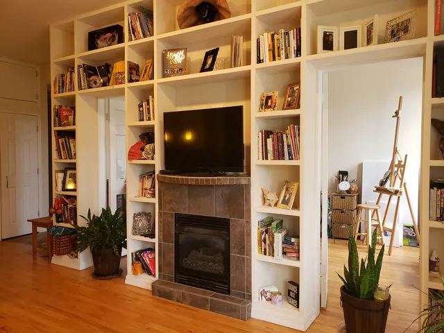a living room with fireplace furniture and a flat screen tv