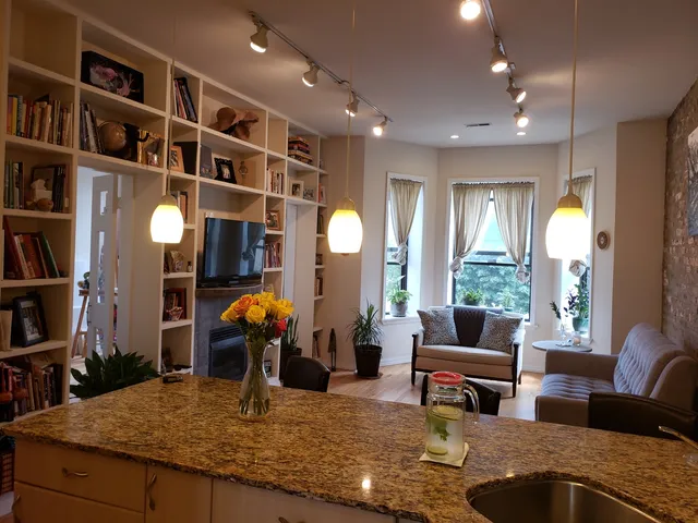 a living room with furniture hard wood floor and a book shelf