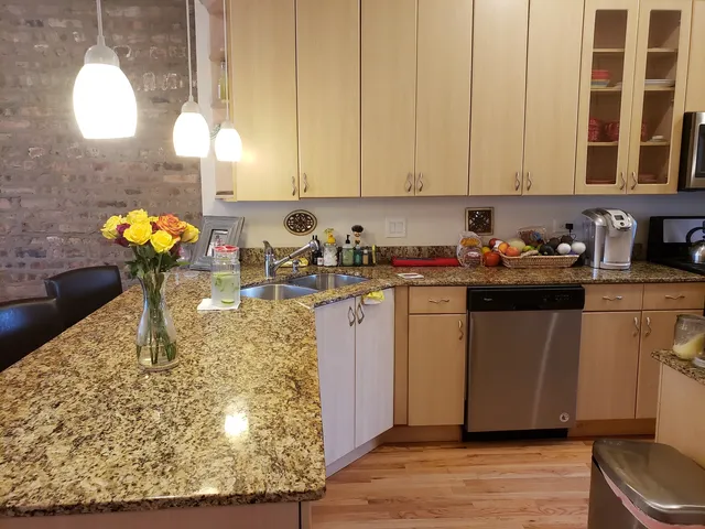 a kitchen with a sink a stove and cabinets