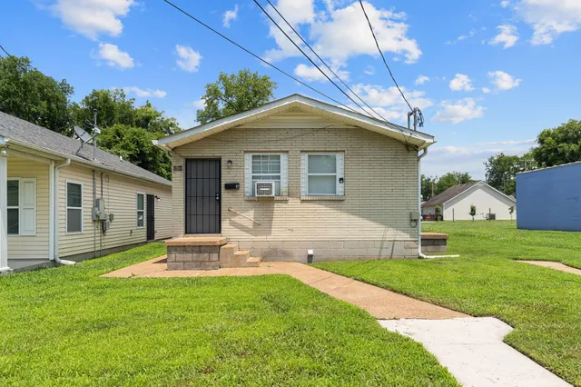 a front view of a house with a yard and porch