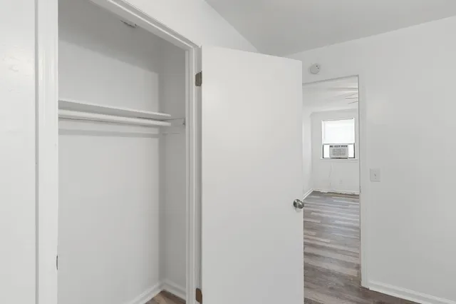 a view of hallway with stairs and wooden floor
