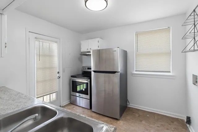 a kitchen with a refrigerator and a sink