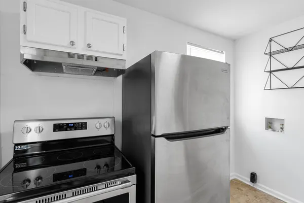 a view of stove top oven with cabinets