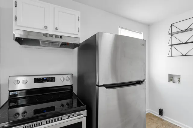 a view of stove top oven with cabinets