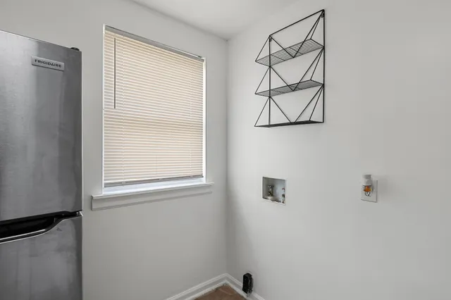 a view of a small space with wooden floor and a window