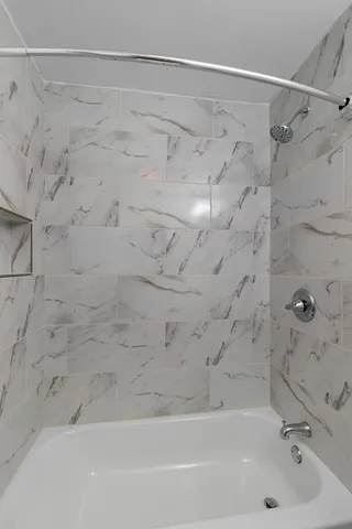 a bathroom with a shower and a shower
