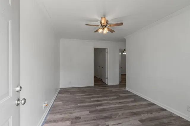 a view of a hallway with wooden floor