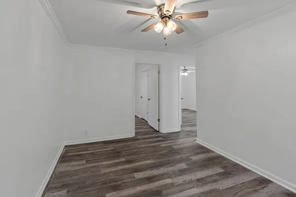 a view of an empty room and wooden floor