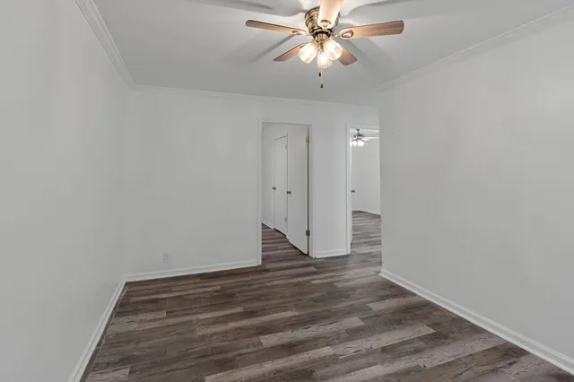 a view of an empty room and wooden floor