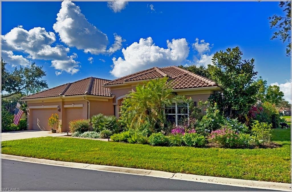 a view of a house with a yard and garden