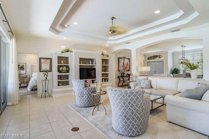 9871 Rookery Circle Estero, FL 33928 - Photo 11 of 38 a living room with furniture a rug and a chandelier