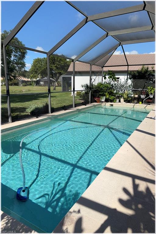 9871 Rookery Circle Estero, FL 33928 - Photo 21 of 33 a view of a backyard with table and chairs under an umbrella