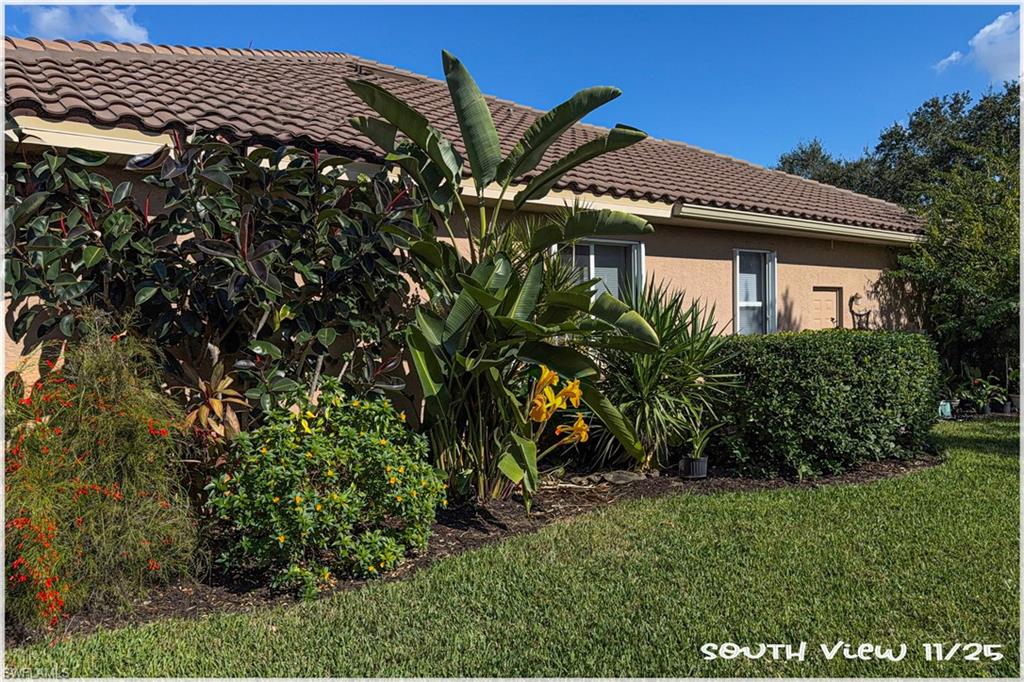 9871 Rookery Circle Estero, FL 33928 - Photo 22 of 33 a front view of a house with a yard