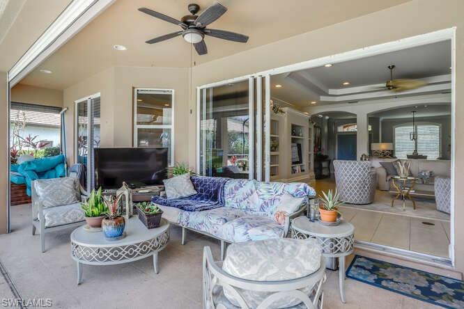 9871 Rookery Circle Estero, FL 33928 - Photo 23 of 38 a living room with furniture potted plant and a large window