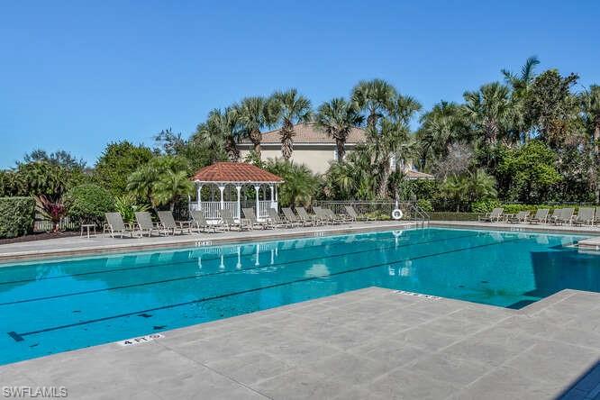9871 Rookery Circle Estero, FL 33928 - Photo 34 of 38 a view of swimming pool with outdoor seating and yard