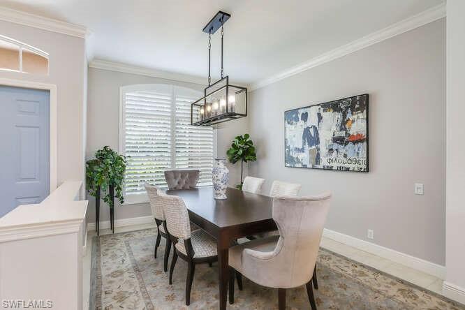 9871 Rookery Circle Estero, FL 33928 - Photo 7 of 38 a view of a dining room with furniture window and wooden floor