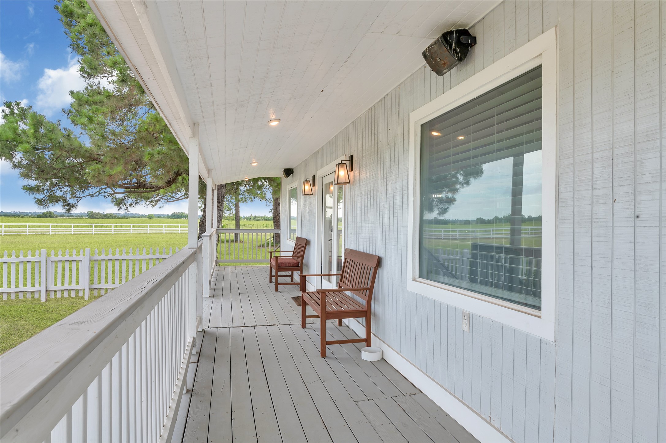 868 Lisa May Road Bellville, TX 77418 - Photo 20 of 39 a view of a balcony with couch and wooden floor