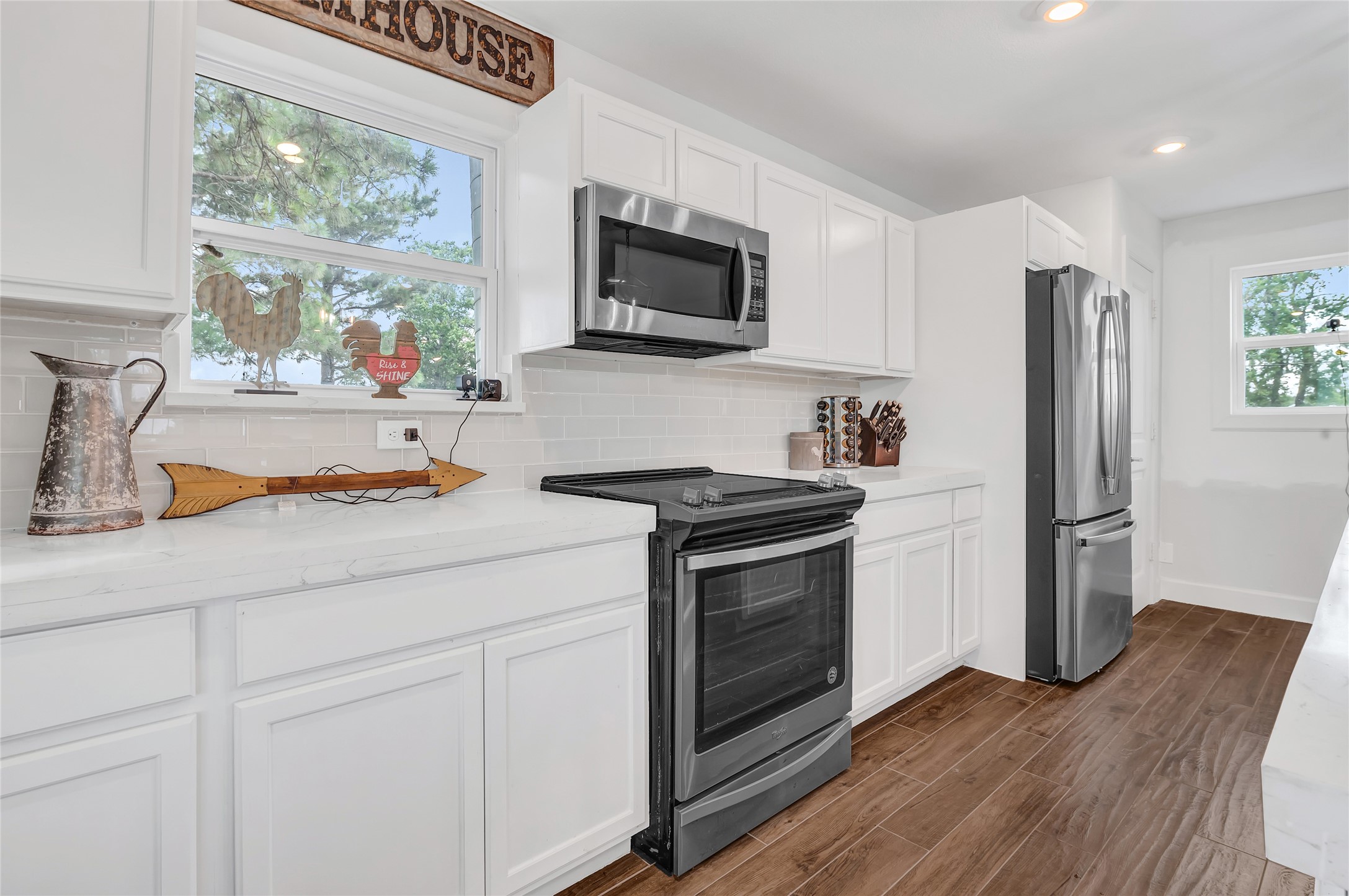 868 Lisa May Road Bellville, TX 77418 - Photo 24 of 39 a kitchen with stainless steel appliances granite countertop a refrigerator and a stove top oven