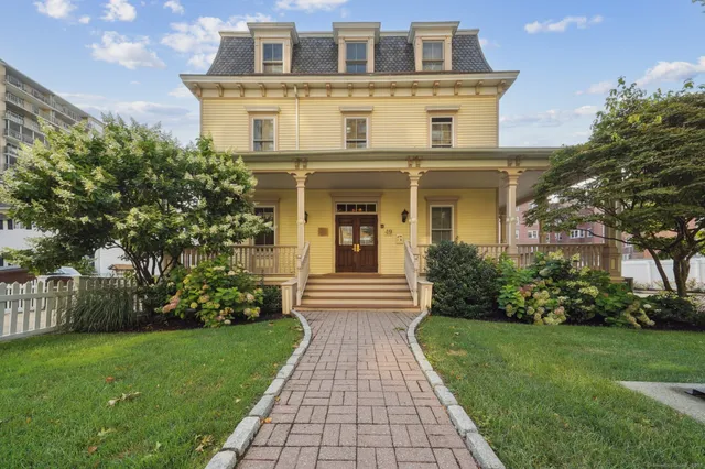 a front view of a house with garden