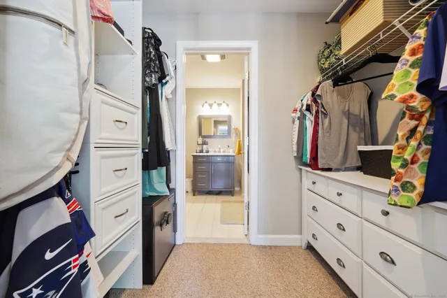 a view of walk in closet with clothes and shoes