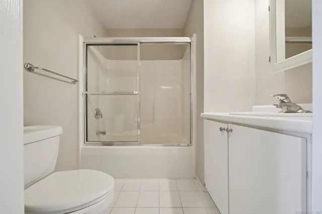 a balcony with wooden floor and outdoor seating