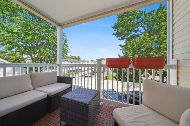 a view of a house with a small yard and wooden fence