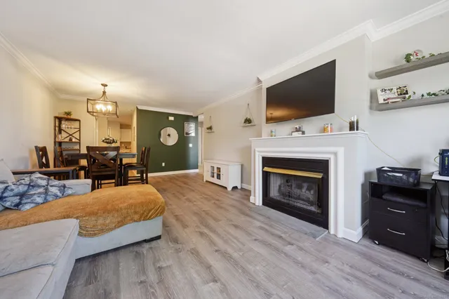 a spacious bedroom with a bed and a flat screen tv