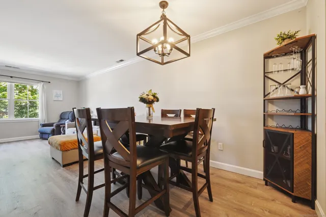 a view of a dining room with furniture window and wooden floor