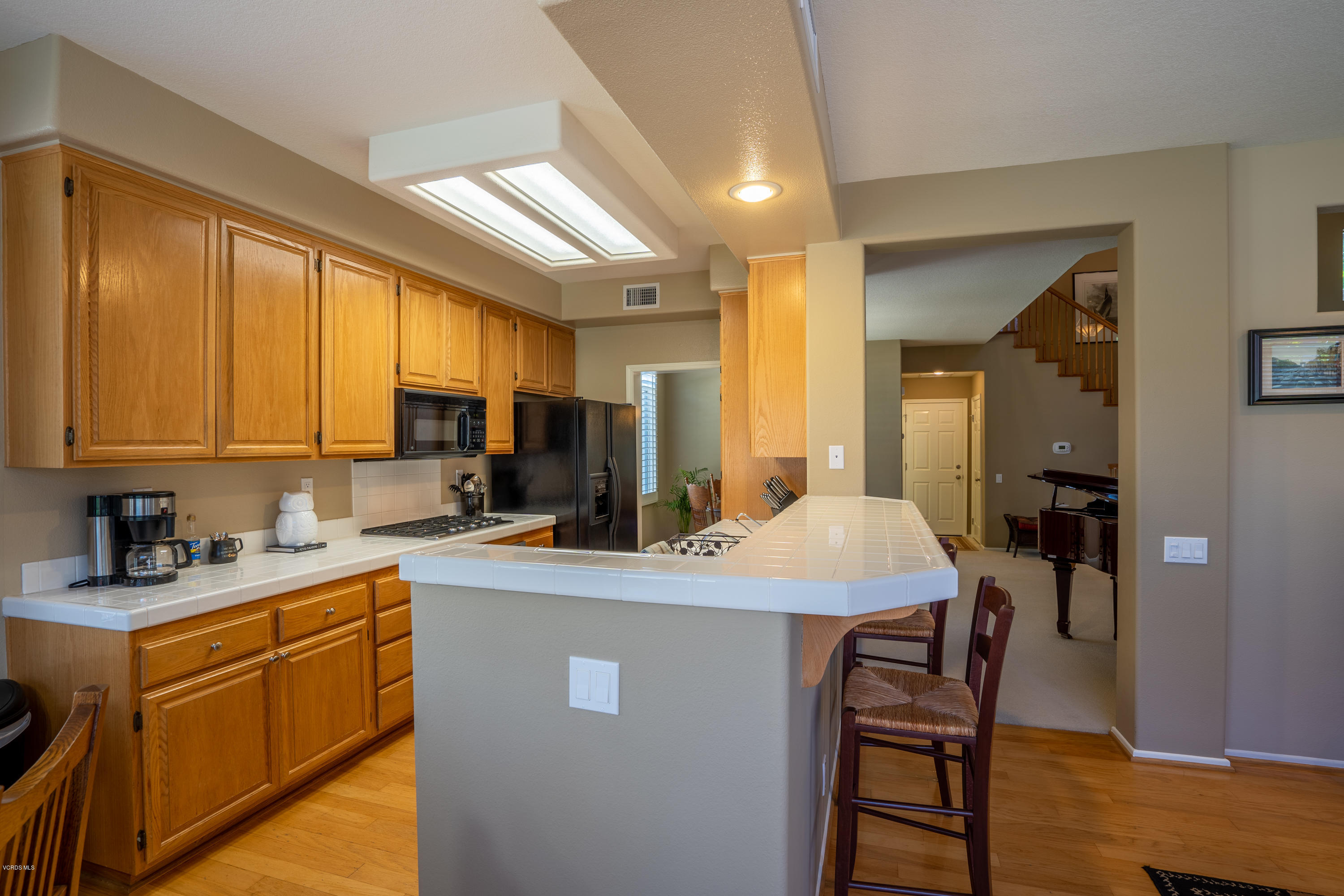 3931 Sunsetridge Road Moorpark, CA 93021 - Photo 12 of 36 a kitchen with a sink a stove a refrigerator cabinets and dining table