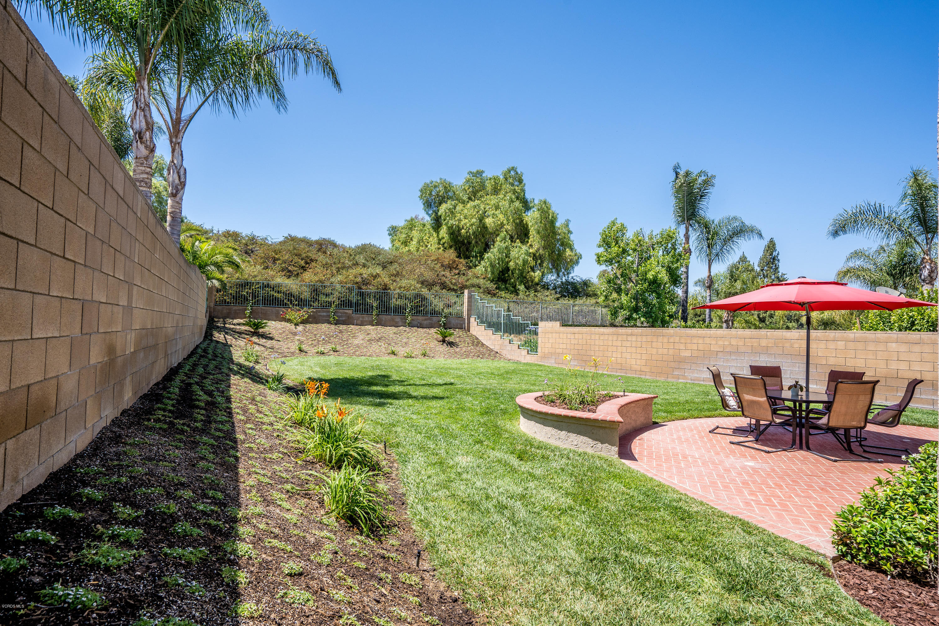 3931 Sunsetridge Road Moorpark, CA 93021 - Photo 26 of 36 a view of a swimming pool with a table and chairs under an umbrella
