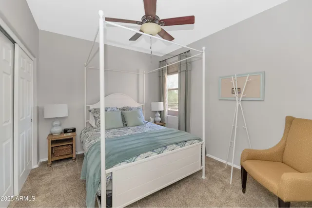 a bedroom with a bed and a chair