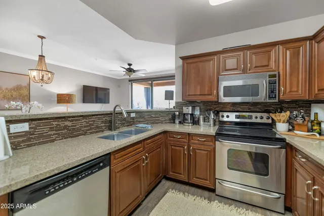 a kitchen with a sink stove and microwave