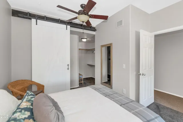 a bedroom with a bed and a chandelier