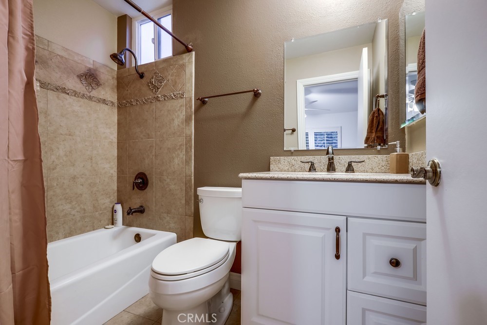 9678 Walker Court Cypress, CA 90630 - Photo 23 of 40 a bathroom with a sink toilet vanity and tub