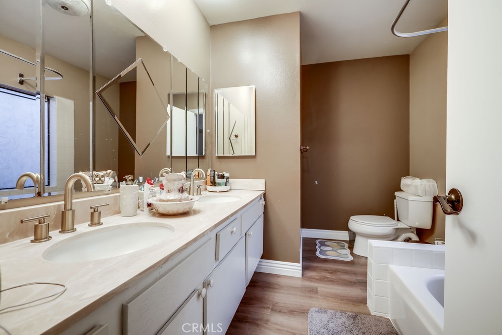 9678 Walker Court Cypress, CA 90630 - Photo 29 of 40 a bathroom with a double vanity sink mirror and toilet