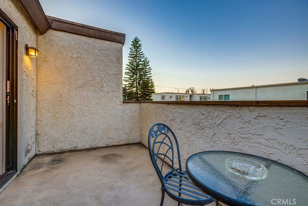 9678 Walker Court Cypress, CA 90630 - Photo 30 of 40 a balcony with table and chairs